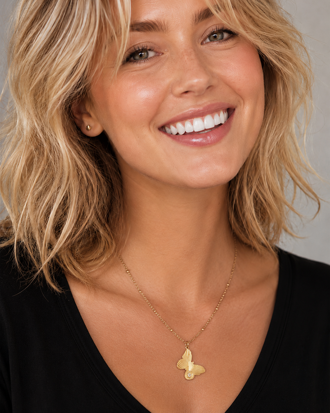 Close-up of the butterfly pendant with a sparkling diamond embedded on the wing
