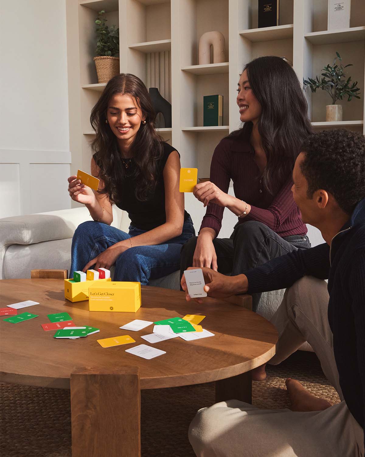 Friends playing the Get Closer Conversation Game during a social gathering