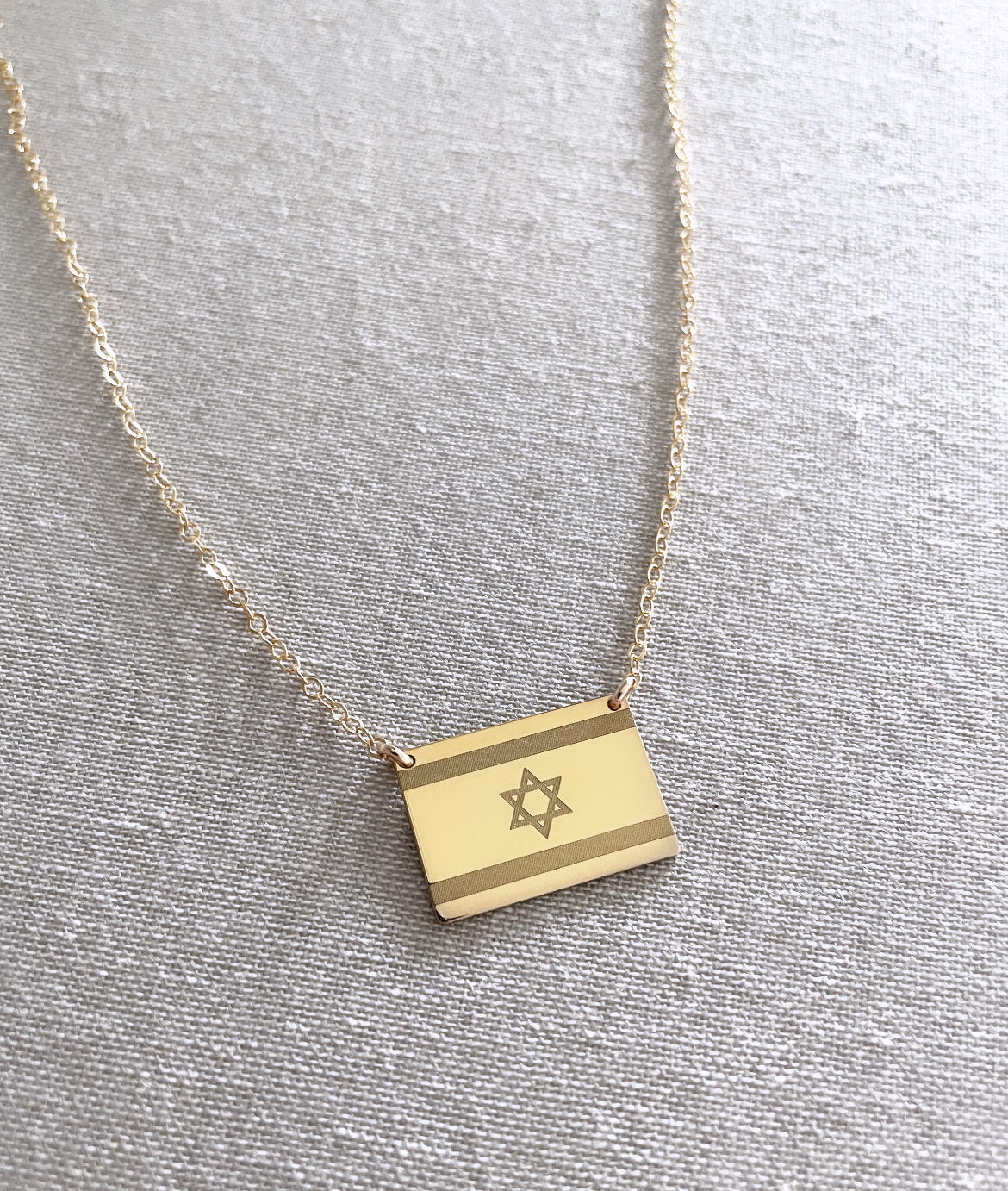 Close-up of engraved Israel flag pendant necklace